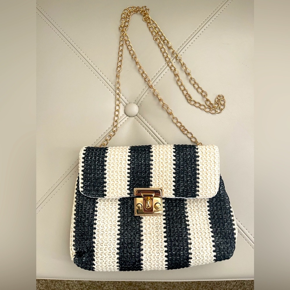 Small Black and White Crossbody with removable gold tone chain strap.